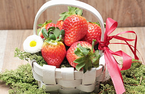 ripe strawberries on white wooden basket