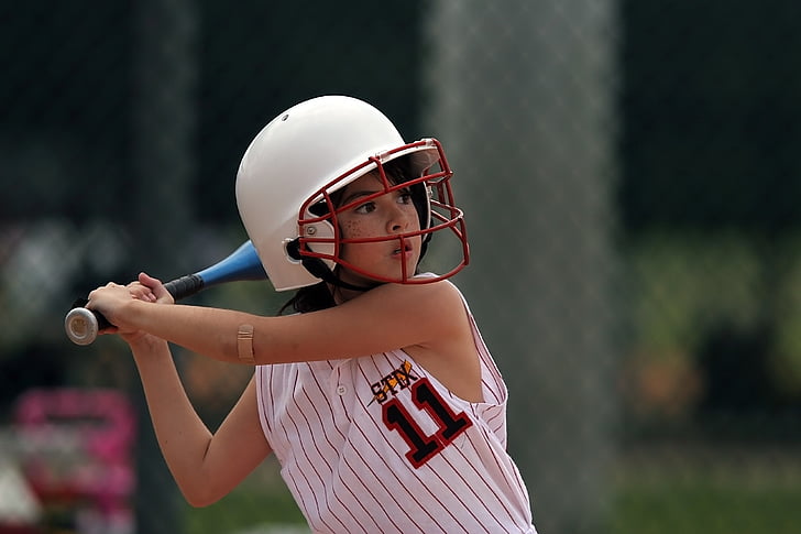 close-up photography of girl holding baseball bat