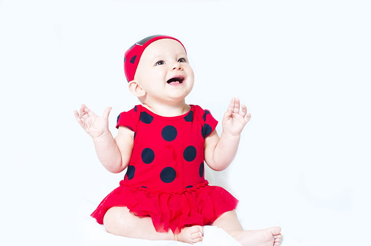 baby in red and black polka-dot shirt dress