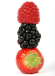 three berries stacked against white background