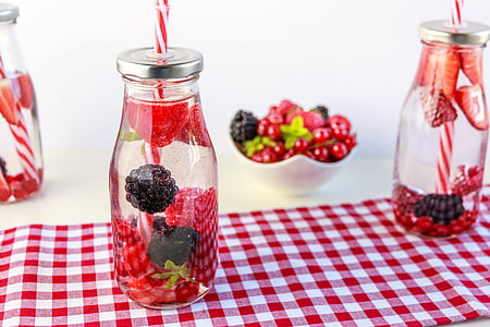 berry filled glass bottle