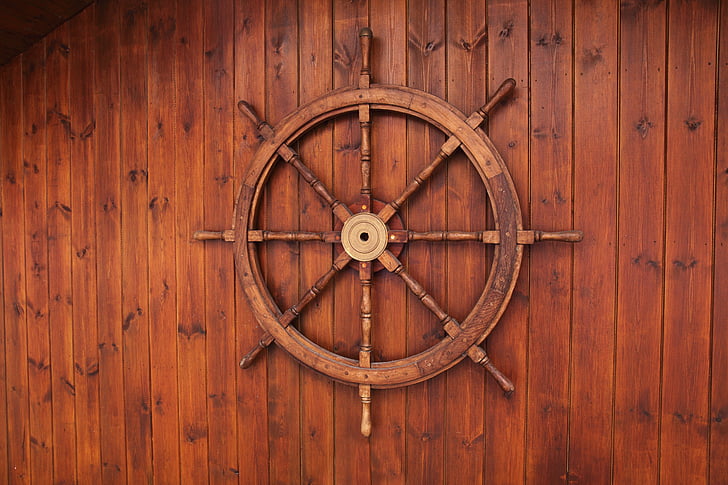 brown wooden ship wheel wall decor