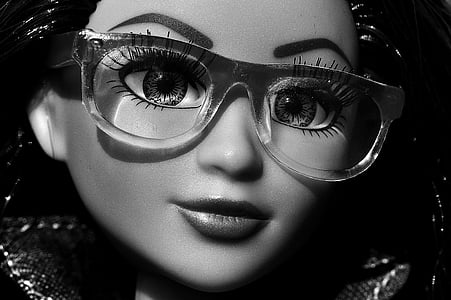 grayscale photography of girl doll wearing eyeglasses
