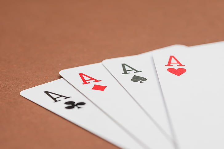 four a playing cards on surface