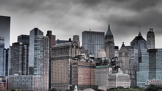 city buildings under gray cloudy sky