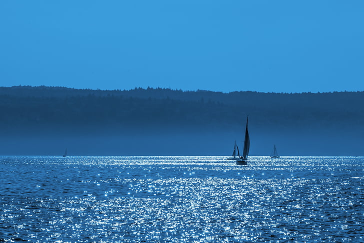 silhouette of sailboat under blue sky
