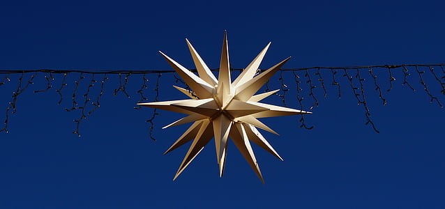 white star lantern hanged on string lights