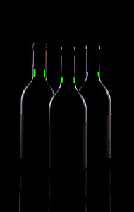 three white bottles on black surface