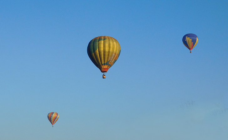 three hot air balloons on sky during daytime