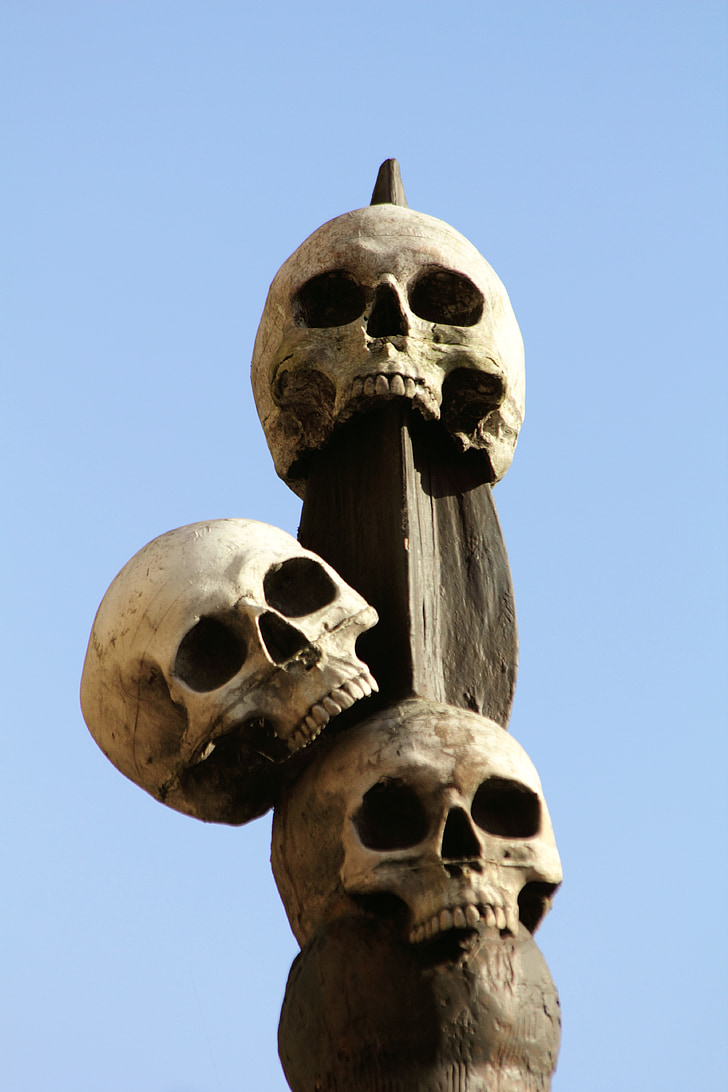 three skull on wooden finial