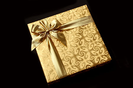 photo of yellow gift box on black background