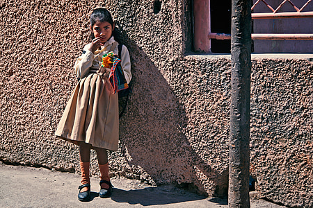 girl standing near concrete wall