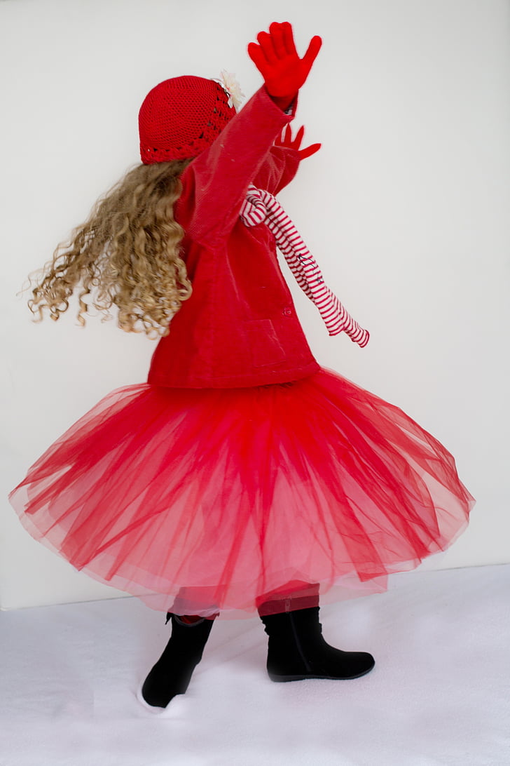 girl wearing red coat and tutu skirt