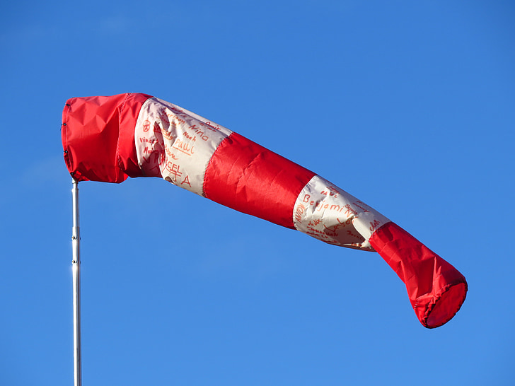 red and white air tube flag with pole