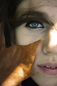 photo of dried leaf on woman's face