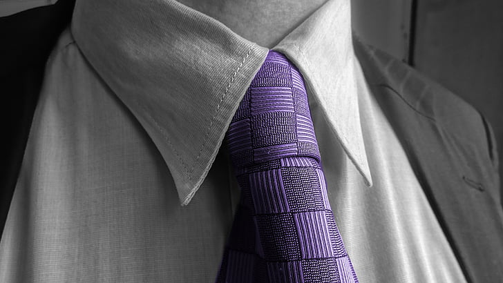 selective color photo of person wearing purple necktie and suit jacket