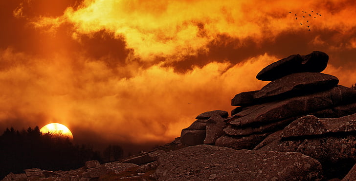 rock under cloudy sky during sunset