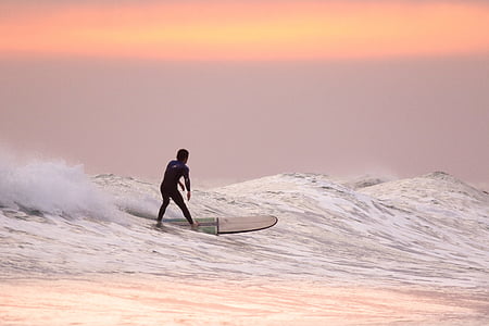 man riding surfboard