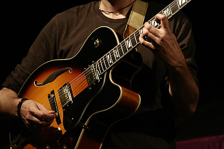 man performing guitar