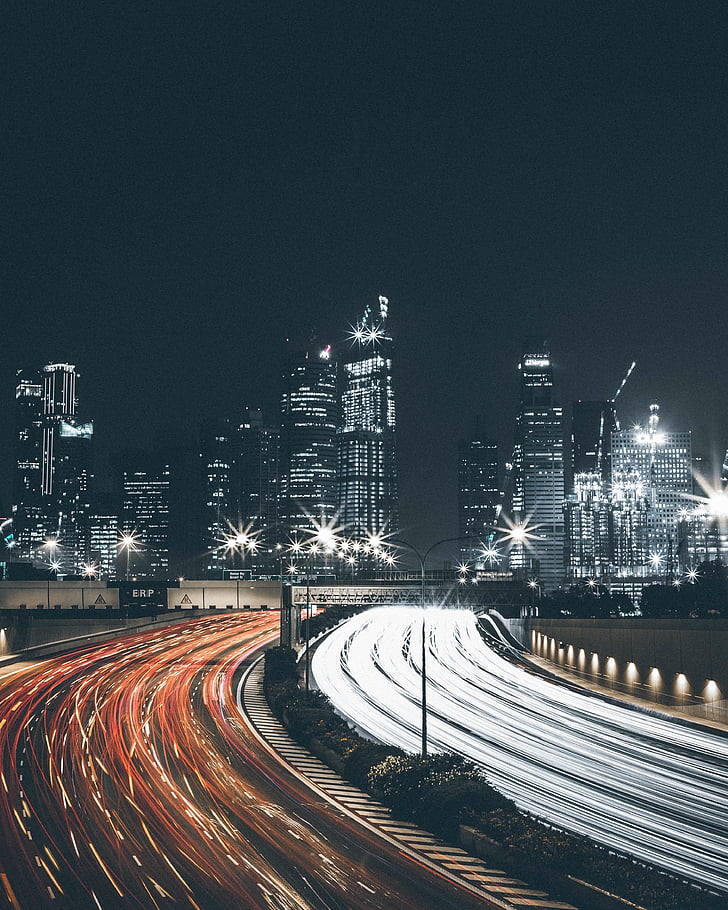 timelapse photography of city buildings and road
