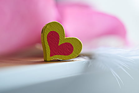 shallow focus photography of yellow and pink heart ornament