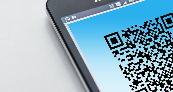 closeup photo of turned on smartphone displaying QR code
