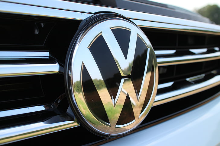 closeup photography of silver-colored Volkswagen vehicle emblem
