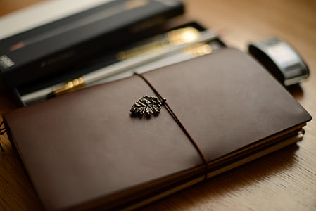 selective focus photography of brown planner