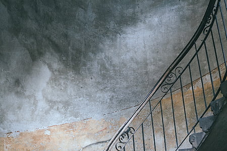 black steel stair railings and gray concrete wall