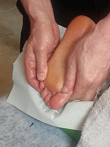 person massaging foot