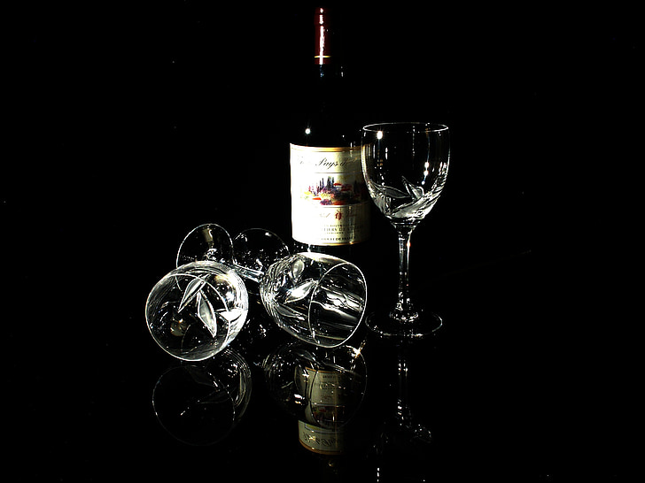 wine bottle with three clear wine glasses