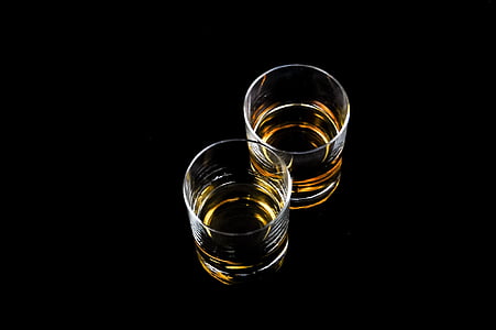 two clear glass cups with brown liquid