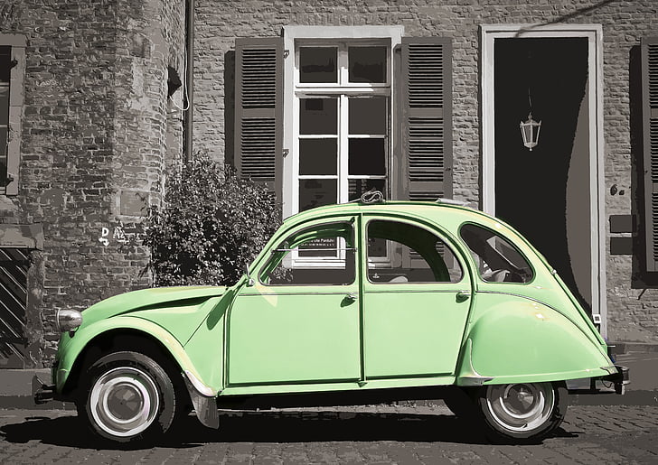 green Volkswagen Beetle parked near white painted wall and black wooden door
