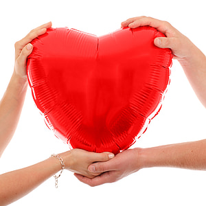 two people holding an inflatable heart