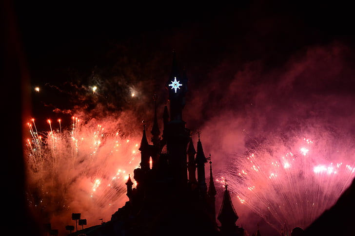 silhouette castle with lighted fireworks at night