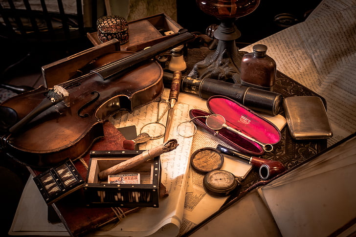 brown violin beside cases