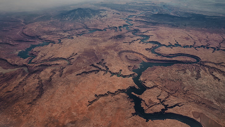 aerial photography of body of water near mountain