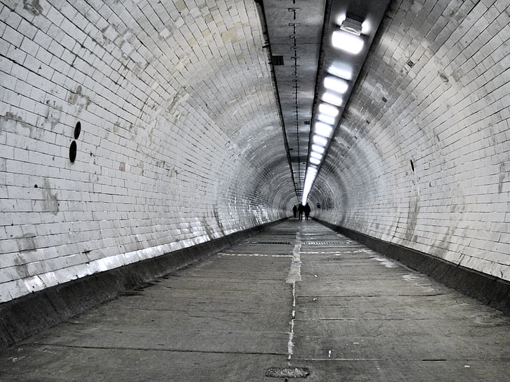 gray painted tunnel with turned on lights