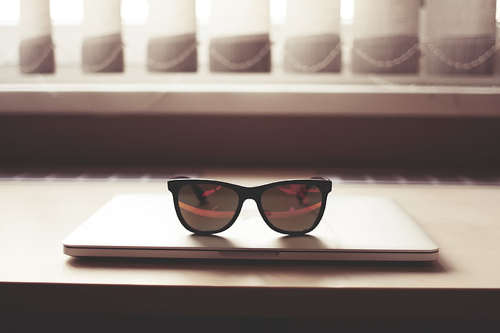 black sunglasses on top of MacBook