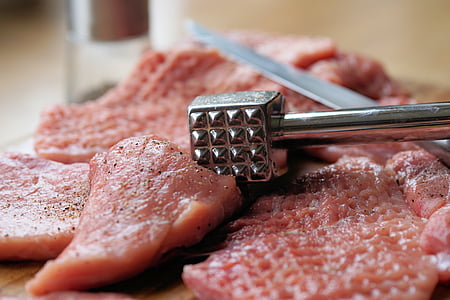 raw meat with gray steel mallet photo