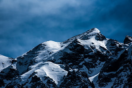 snow covered mountain under white sky