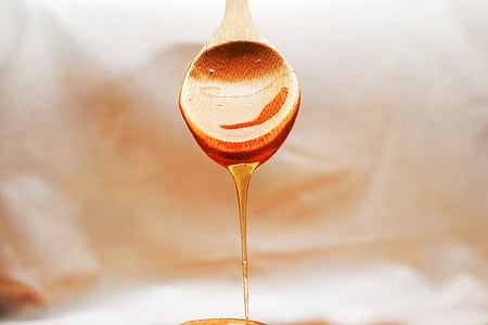 selective photography of dropped honey