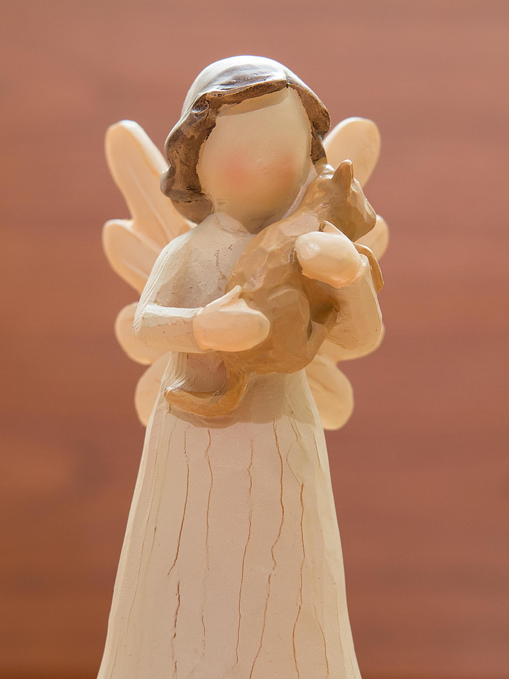 angel holding bear plush toy wooden sculpture
