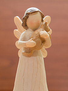 angel holding bear plush toy wooden sculpture