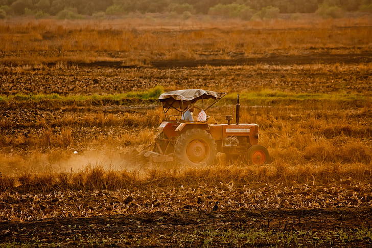 red tractor on brown field