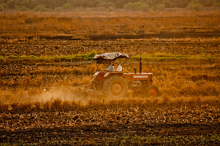 red tractor on brown field
