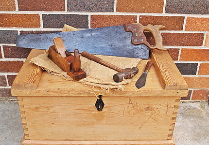 assorted hand tools on top of brown wooden box
