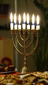 brass-colored menorah with candles