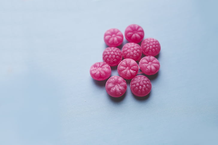 round pink candies on blue panel
