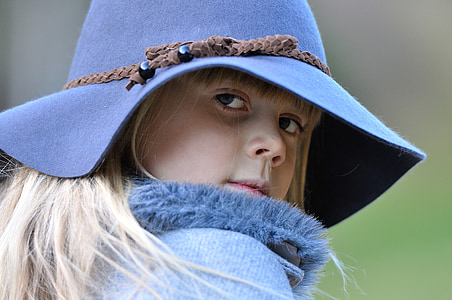 selective focus photography of girl wearing blue sunhat